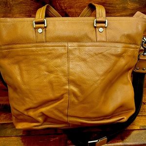 Leather Coach tote bag in pecan color and brass hardware and zipper top closure